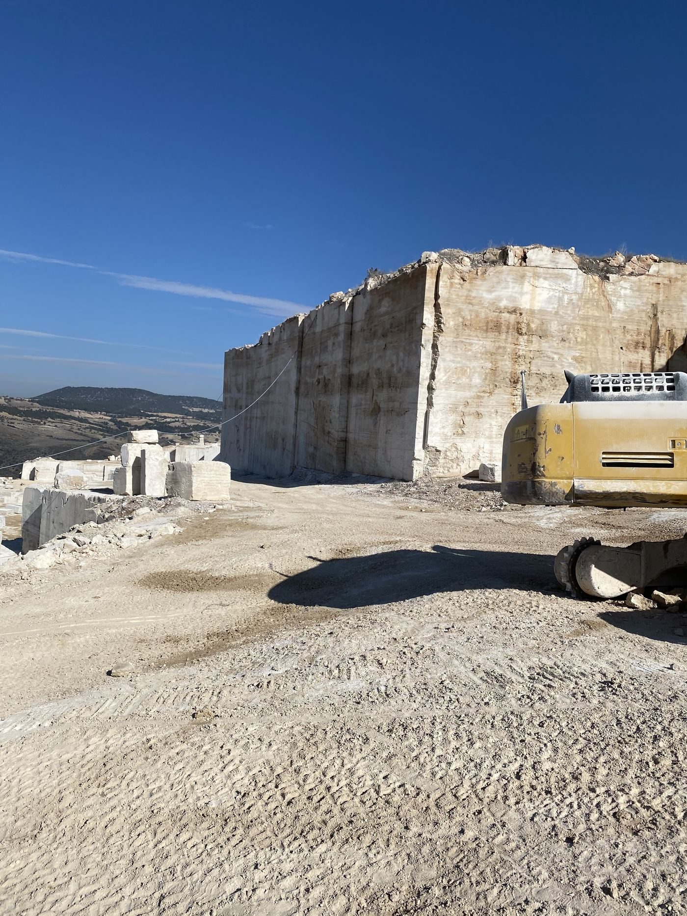Bloc de pierre calcaire claire en cours d'extraction en carrière.